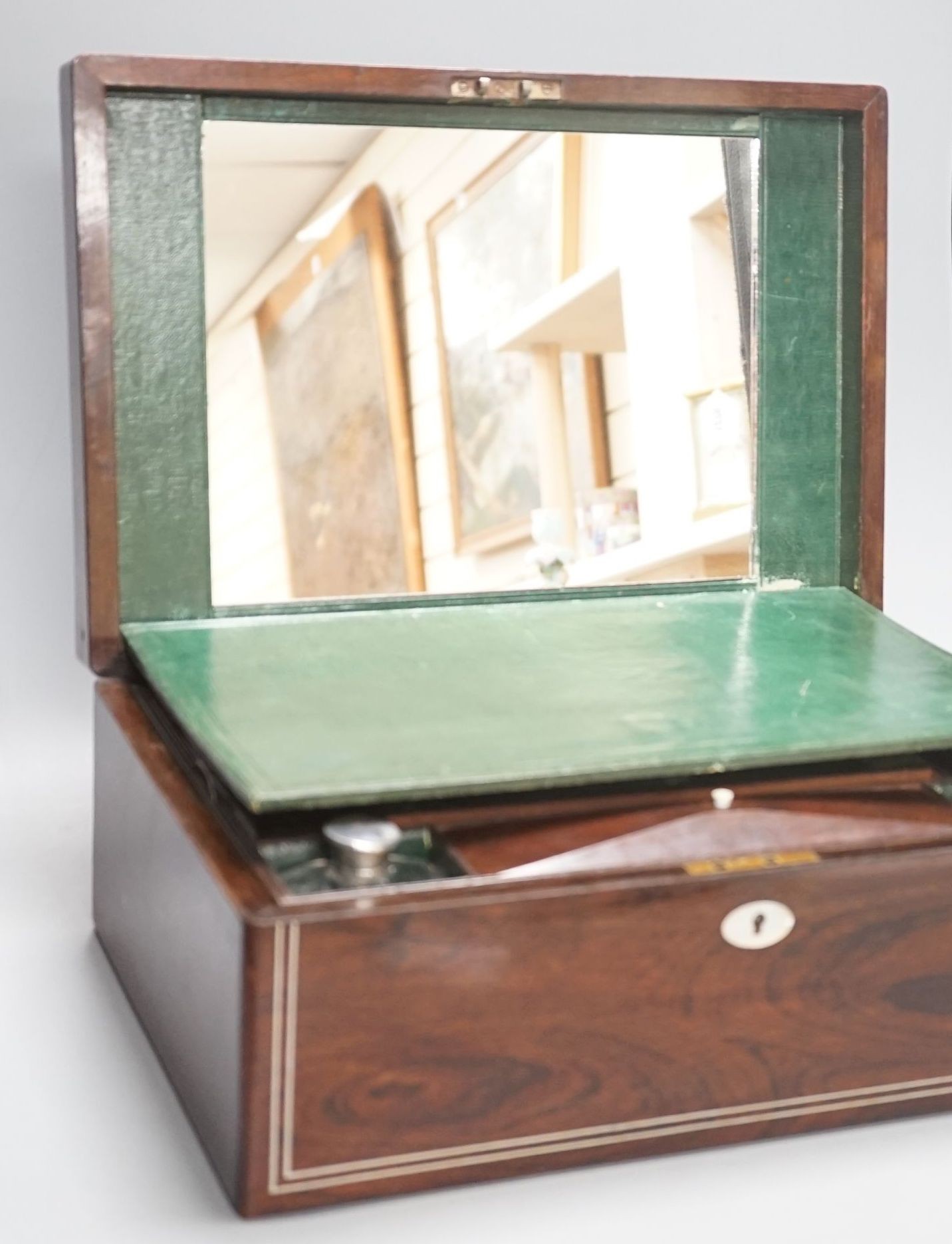 A Victorian rosewood sewing box containing white metal lidded glass bottles, box 37 cms wide x 15 cms high.